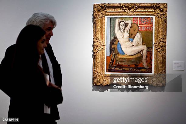 Visitors stand near "Nu au coussin bleu" by Henri Matisse during a preview at Christie's International Ltd. In New York, U.S., on Friday, April 30,...