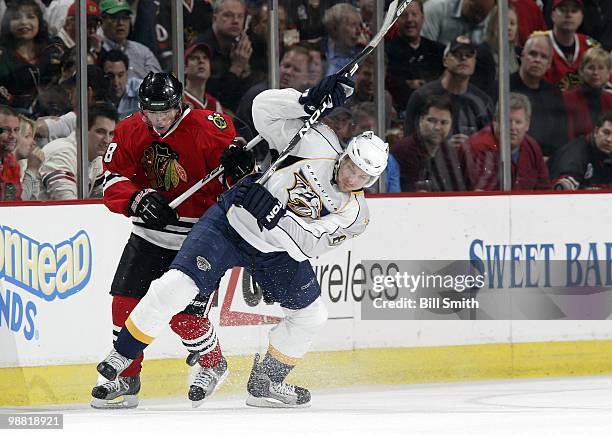 Kevin Klein of the Nashville Predators gets tripped up in front of Patrick Kane of the Chicago Blackhawks at Game Two of the Western Conference...