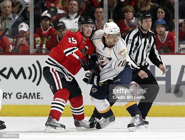 Jonathan Toews of the Chicago Blackhawks and Martin Erat of the Nashville Predators fight for position on the ice at Game Two of the Western...