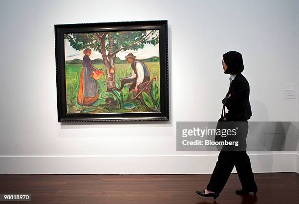 Visitor walks by "Fertility," a painting by Edvard Munch, during a preview at Christie's International Ltd. In New York, U.S., on Friday, April 30,...