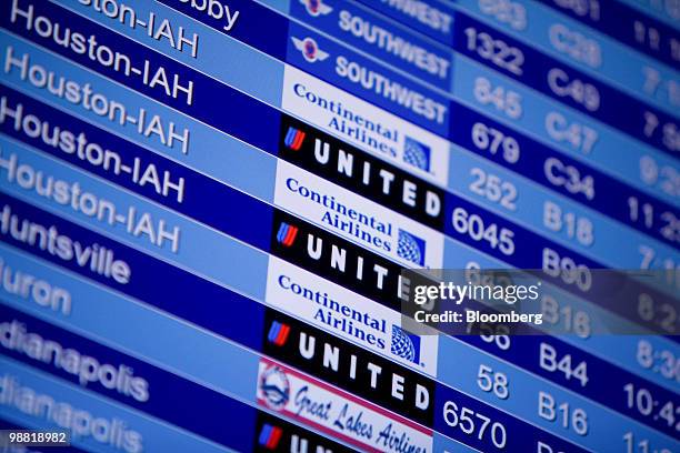 The departure board shows Continental Airlines and United Airlines flights at Denver International Airport in Denver, Colorado, U.S., on Monday, May...