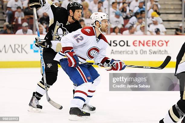 Dominic Moore of the Montreal Canadiens and Mark Eaton of the Pittsburgh Penguins battle for position in Game One of the Eastern Conference...