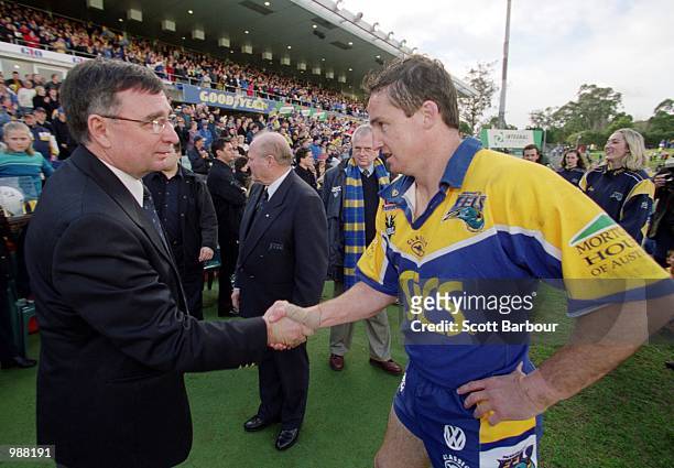 David Moffett, Chief Executive of the National Rugby League congratulates Jason Taylor for Parramatta after setting a new points scoring record...