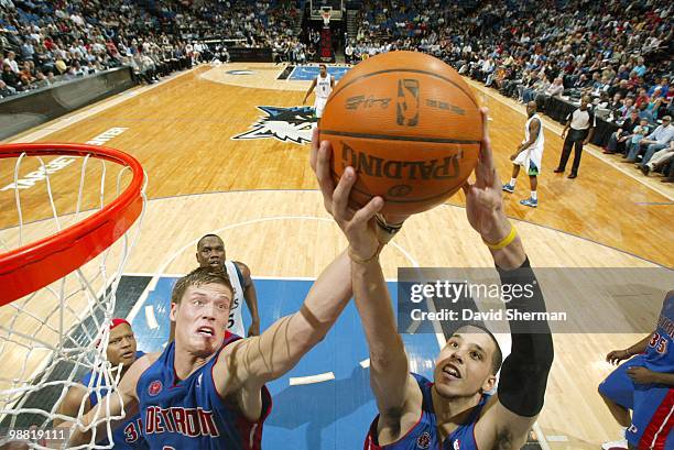 Jonas Jerebko and Austin Daye of the Detroit Pistons go up for a loose ball against the Minnesota Timberwolves during the game at Target Center on...