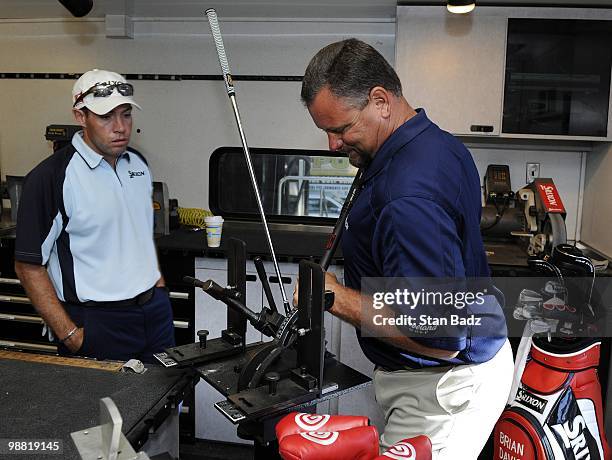 Golfer Brian Davis, and Dean Teykl, Srixon Tour Manager adjusts clubs in the Cleveland equipment truck during practice for THE PLAYERS Championship...