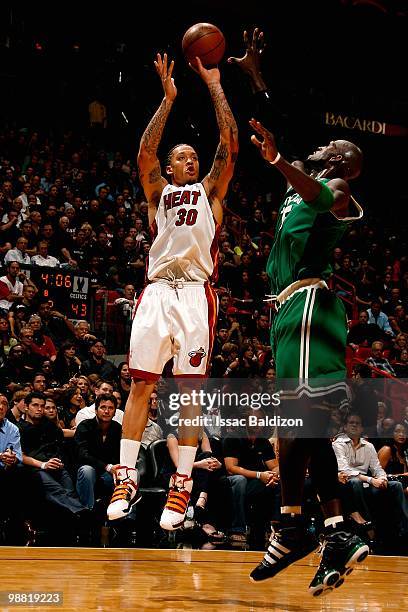 Michael Beasley of the Miami Heat shoots over Kevin Garnett of the Boston Celtics in Game Three of the Eastern Conference Quarterfinals during the...