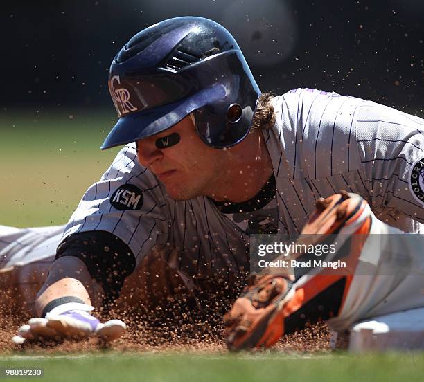 Troy Tulowitzki of the Colorado Rockies slides safely into third base during the game between the Colorado Rockies and the San Francisco Giants on...