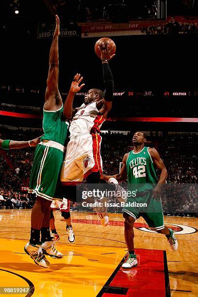 Dwyane Wade of the Miami Heat looks to pass against Kendrick Perkins and Tony Allen of the Boston Celtics in Game Three of the Eastern Conference...