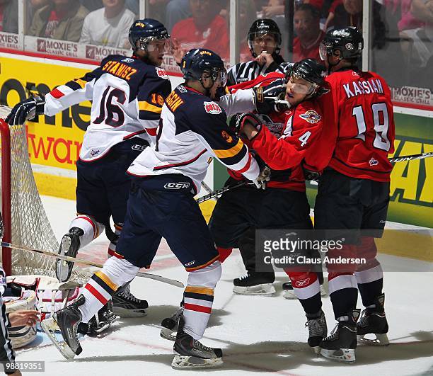 Chris Wiggin of the Barrie Colts takes a poke at Taylor Hall of the Windsor Spitfires in the third game of the OHL Championship final on May 2,2010...