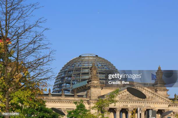 dome and famous inscription on the architrave on the west portal of the reichstag building in berlin: "dem deutschen volke" (germany) - architrave stock pictures, royalty-free photos & images