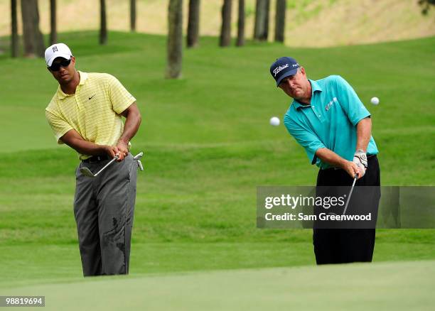 Tiger Woods and Jay Haas hit shots during a practice round for THE PLAYERS at TPC Sawgrass on May 3, 2010 in Ponte Vedra Beach, Florida.