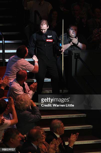 Graeme Dott of Scotland makes his entrance for match against Neil Robertson of Australia during the final of the Betfred.com World Snooker...