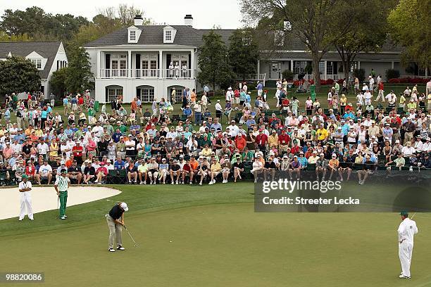 Ryo Ishikawa watches as Ernie Els putts on the 9th hole during the first round of the 2010 Masters Tournament at Augusta National Golf Club on April...