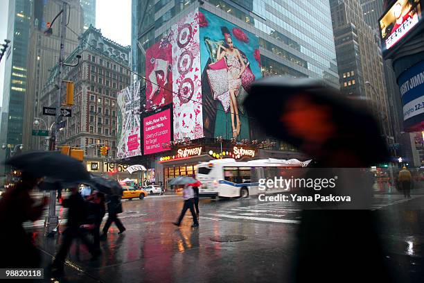 Pedestrians walk past the corner of 42nd Street and 7th Avenue in Times Square May 3, 2010 in New York City. The area resumed normal operations, with...