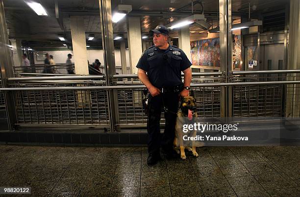 Police officer and his dog, Buster, watch pedestrians in the subway station on the corner of 42nd Street and 7th Avenue in Times Square May 3, 2010...