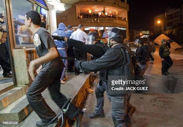 Israeli riot police scatters Arab Israelis during a demonstration against demolitions of illegal building, in the Arab Israeli city of Taibe, north...