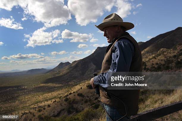 Rancher Geoffrey Patch looks over the border between the United States and Mexico on May 2, 2010 from Montezuma Pass, Arizona. Although the U.S....
