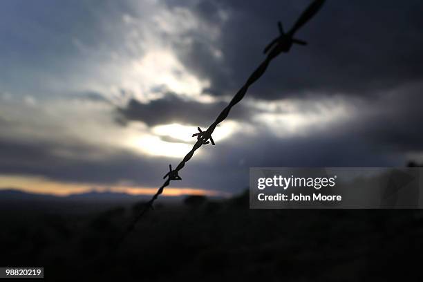 Barbed wire fence stretches across the border between the United States and Mexico on May 2, 2010 at Montezuma Pass, Arizona. Although the U.S....