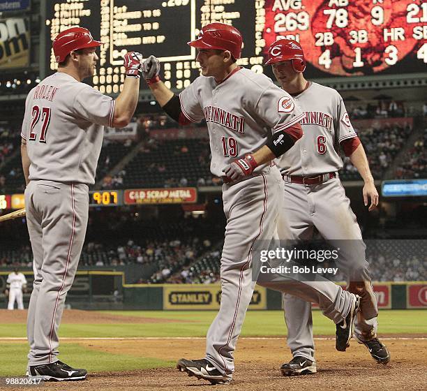 Joey Votto of the Cincinnati Reds receives congratulations from Drew Stubbs and Scott Rolen hitting a home run against the Houston Astros at Minute...