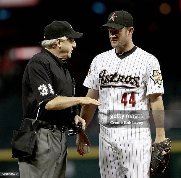 Pitcher Roy Oswalt of the Houston Astros talks with home plate umpire Mike Reilly during a baseball game against the Cincinnati Reds at Minute Maid...