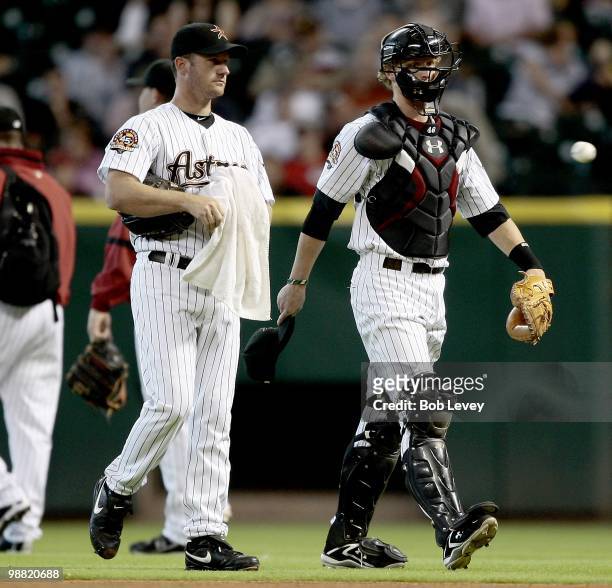 Pitcher Roy Oswalt and catcher J.R. Towles of the Houston Astros make their way in from the bullpen before a baseball game against the Cincinnati...