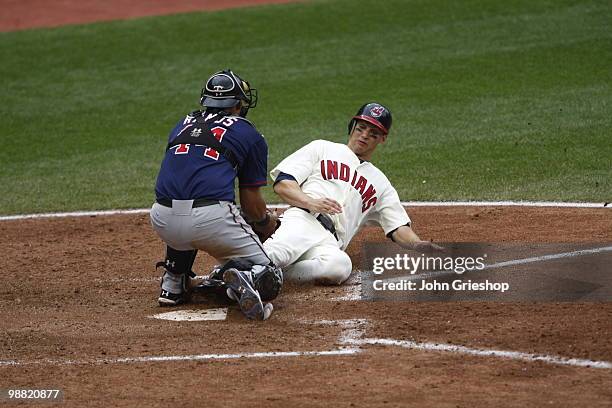 Grady Sizemore of the Cleveland Indians is tagged out at the plate by Wilson Ramos of the Minnesota Twins during the game between the Minnesota Twins...