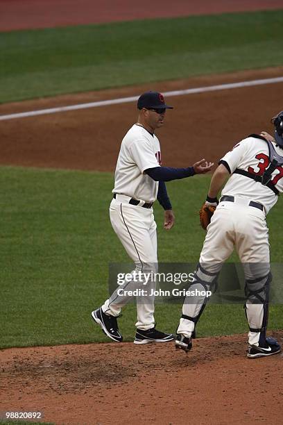 Manager Manny Acta of the Cleveland Indians makes a pitching change during the game between the Minnesota Twins and the Cleveland Indians on Sunday,...