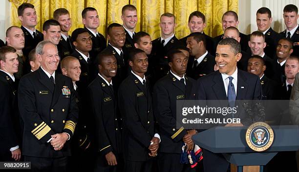 President Barack Obama speaks alongside members of the US Naval Academy football team during a ceremony where Obama presents the Commander in Chief...
