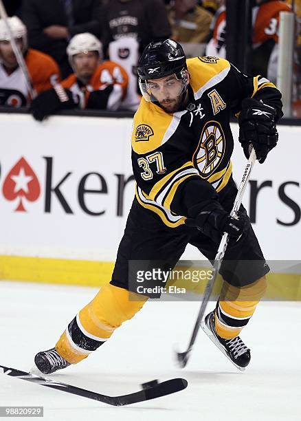 Patric Bergeron of the Boston Bruins takes a shot in the third period against the Philadelphia Flyers in Game One of the Eastern Conference...