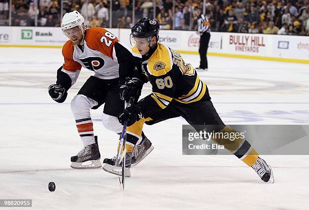 Vladimir Sobotka of the Boston Bruins and Claude Giroux of the Philadelphia Flyers fight for the puck in Game One of the Eastern Conference...