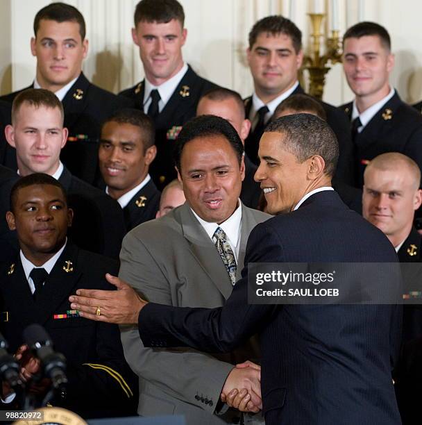President Barack Obama shakes hands with US Naval Academy football team head coach Ken Niumatalolo during a ceremony where Obama presents the...