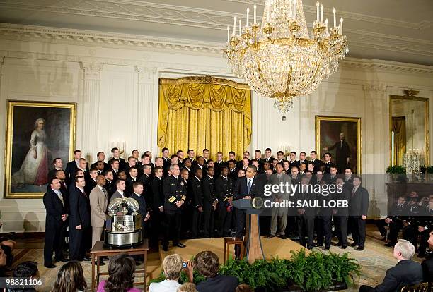President Barack Obama speaks alongside members of the US Naval Academy football team during a ceremony where Obama presents the Commander in Chief...