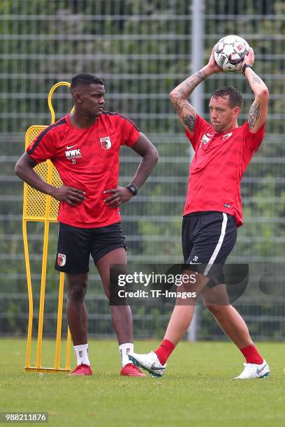 Sergio Cordova of Augsburg and Julian Schieber of Augsburg look on during a FC Augsburg Training session on June 28, 2018 in Augsburg, Germany.