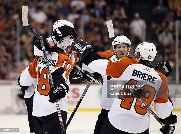 Mike Richards, Danny Briere and Kimmo Timonen of the Philadelphia Flyers congratulate teammate Chris Pronger after his goal in the second period...
