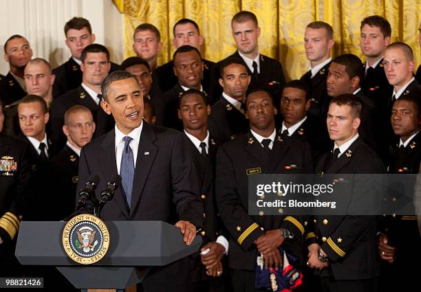 President Barack Obama laughs during the Commander in Chief trophy presentation with the U.S. Naval Academy football team in the East Room of the...