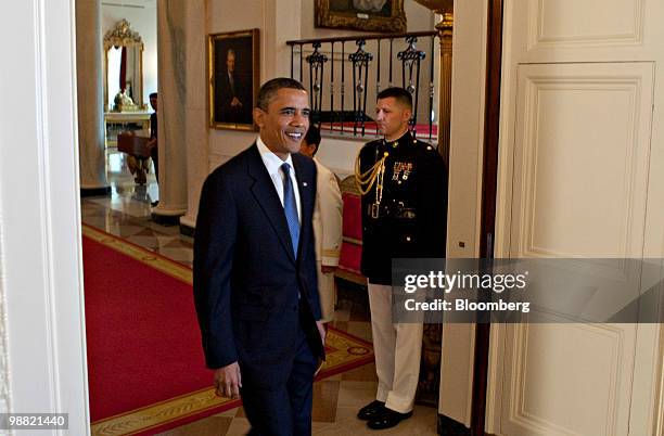 President Barack Obama arrives to speak during the Commander in Chief trophy presentation with the U.S. Naval Academy football team in the East Room...