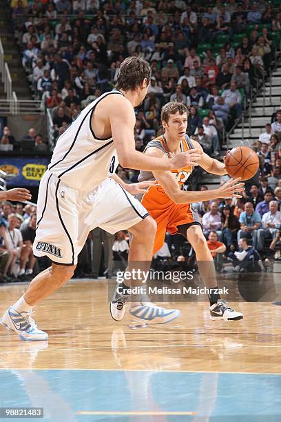 Goran Dragic of the Phoenix Suns moves the ball against Mehmet Okur of the Utah Jazz during the game at EnergySolutions Arena on April 14, 2010 in...