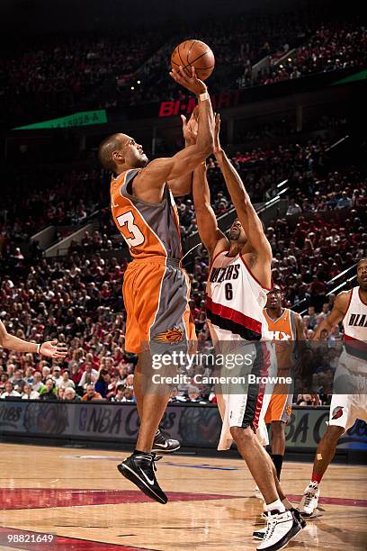 Grant Hill of the Phoenix Suns shoots over Juwan Howard of the Portland Trail Blazers in Game Three of the Western Conference Quarterfinals during...