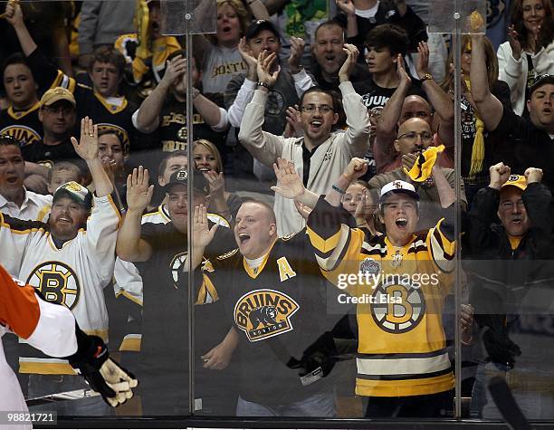 Boston Bruins fans celebrate a stop by Bruins goaltender Tuukka Rask in the second period against the Philadelphia Flyers in Game One of the Eastern...