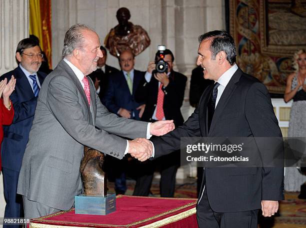 King Juan Carlos of Spain delivers a lifetime achievement award to former golf player Severiano Ballesteros, during the 'National Sports Awards' 2009...