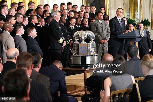 President Barack Obama speaks as he hosts members of the Navy football team Midshipmen during the presentation ceremony of the Commander-in-Chief's...
