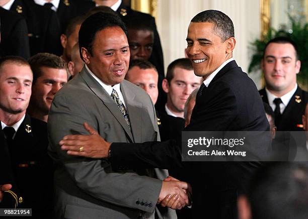 President Barack Obama greets head coach Ken Niumatalolo as he hosts members of the Navy football team Midshipmen during the presentation ceremony of...