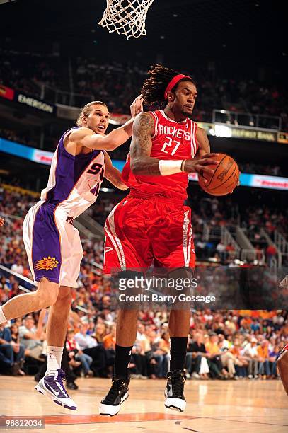 Jordan Hill of the Houston Rockets rebounds the ball against Louis Amundson of the Phoenix Suns during the game at U.S. Airways Center on April, 2010...