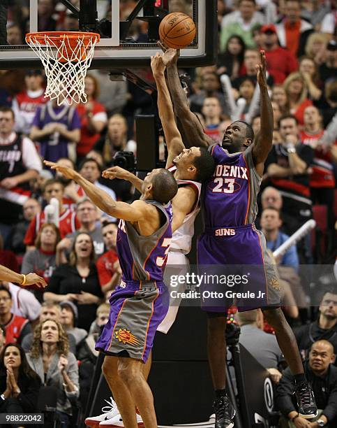 Brandon Roy of the Portland Trail Blazers rebounds against Jason Richardson and Grant Hill of the Phoenix Suns during Game Six of the Western...