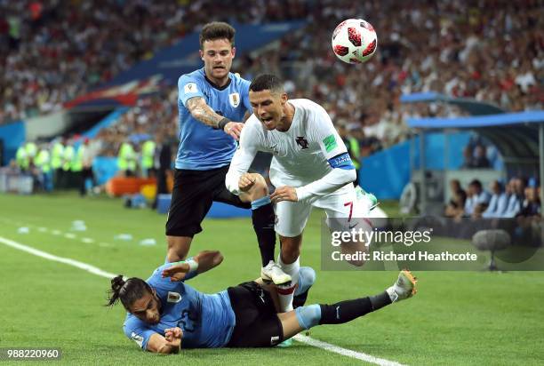 Cristiano Ronaldo of Portugal is fouled by Martin Caceres of Uruguay during the 2018 FIFA World Cup Russia Round of 16 match between Uruguay and...