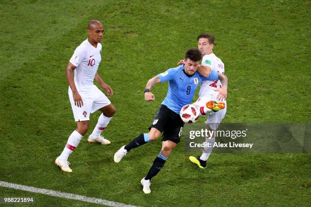 Nahitan Nandez of Uruguay is challenged by Adrien Silva of Portugal during the 2018 FIFA World Cup Russia Round of 16 match between Uruguay and...