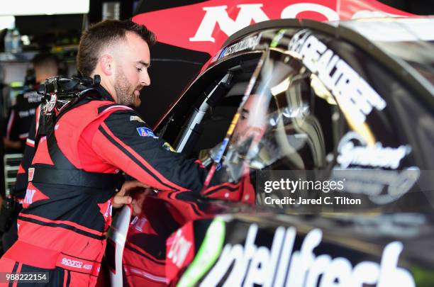 Austin Dillon, driver of the Dow Intellifresh Chevrolet, gets into his car during practice for the Monster Energy NASCAR Cup Series Overton's 400 at...