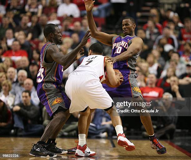 Brandon Roy of the Portland Trail Blazers in action against Jason Richardson and Jarron Collins of the Phoenix Suns during Game Six of the Western...
