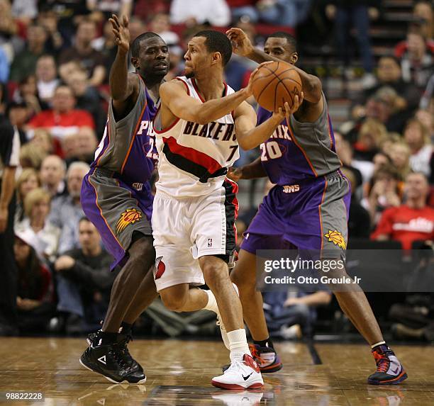 Brandon Roy of the Portland Trail Blazers in action against Jason Richardson and Jarron Collins of the Phoenix Suns during Game Six of the Western...