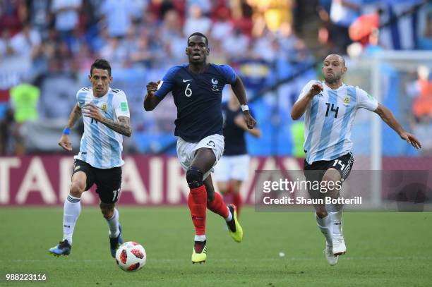 Paul Pogba of France breaks away from Angel Di Maria and Javier Mascherano of Argentina during the 2018 FIFA World Cup Russia Round of 16 match...